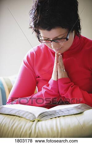 Woman praying on bed View Large Photo Image Stock Photo - Woman praying on bed. Fotosearch