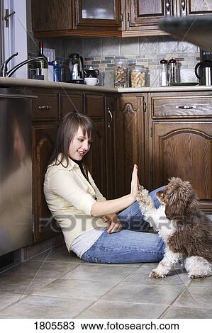 Stock Image - Woman spending time with her dog. Fotosearch