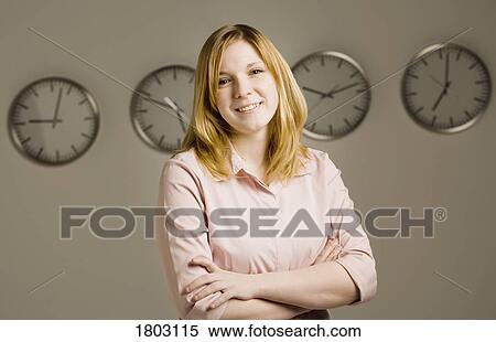 Woman standing in front of clocks View Large Photo Image Stock Photography - Woman standing in front of clocks. Fotosearch