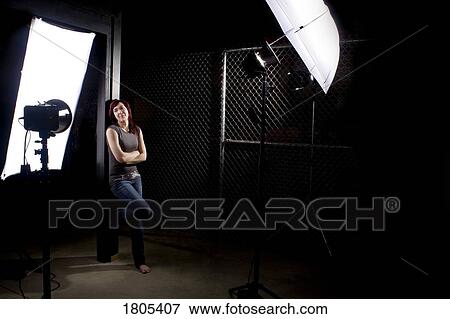 Woman standing in the midst of photography equipment View Large Photo Image Stock Photo - Woman standing in the midst of photography equipment. Fotosearch