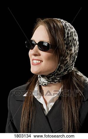 Picture - Woman wearing a scarf and sunglasses. Fotosearch