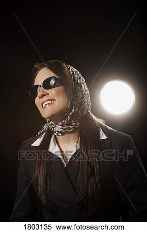 Stock Photography - Woman wearing a scarf and sunglasses. Fotosearch
