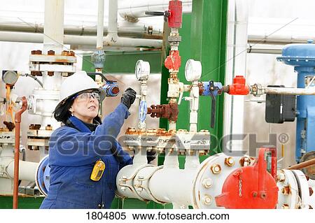 Woman working on a boiler system View Large Photo Image Stock Photography - Woman working on a boiler system. Fotosearch