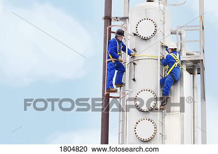 Workers working in an industrial plant View Large Photo Image Stock Image - Workers working in an industrial plant. Fotosearch