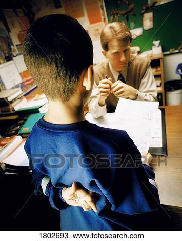 Young boy handing in his schoolwork View Large Photo Image Stock Image - Young boy handing in his schoolwork. Fotosearch