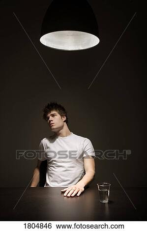 Stock Photograph - Young man being interrogated. Fotosearch