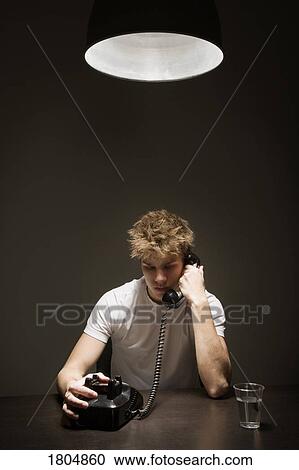 Young man talking on the phone View Large Photo Image Stock Image - Young man talking on the phone. Fotosearch