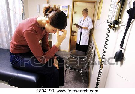 Young woman in a doctor's office View Large Photo Image Stock Image - Young woman in a doctor's office. Fotosearch