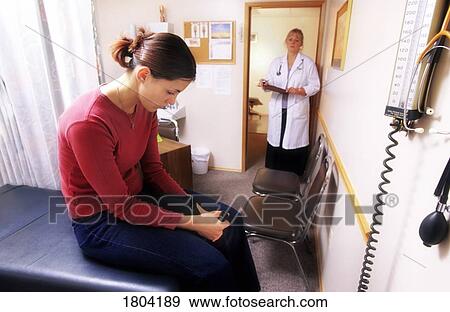 Young woman in a doctor's office View Large Photo Image Stock Photo - Young woman in a doctor's office. Fotosearch