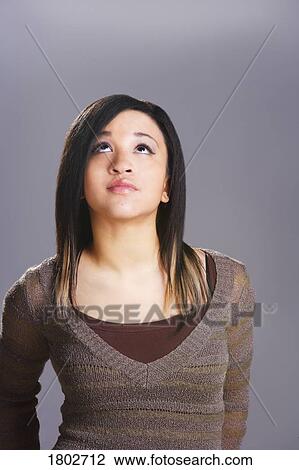 Young woman looking upward View Large Photo Image Stock Image - Young woman looking upward. Fotosearch