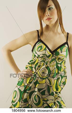 Young woman modelling retro-patterned babydoll dress View Large Photo Image Stock Photograph - Young woman modelling retro-patterned babydoll dress. Fotosearch
