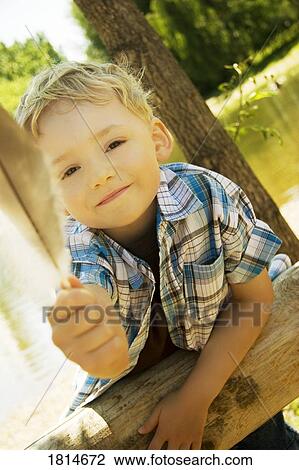 A boy holding a feather View Large Photo Image Stock Image - A boy holding a feather. Fotosearch
