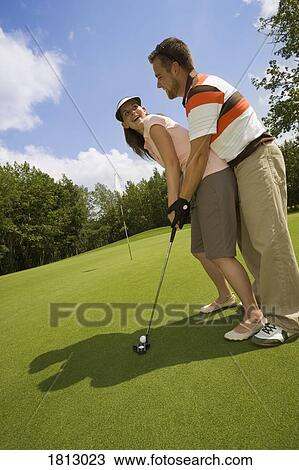 A couple golfing View Large Photo Image Stock Image - A couple golfing. Fotosearch