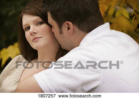 Stock Photo - Attractive woman enjoying man's attention . Fotosearch