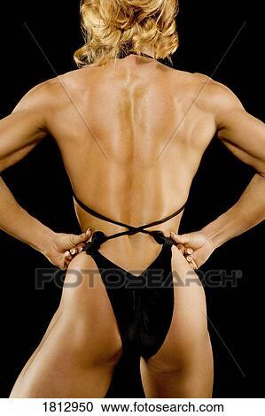 Stock Image - Back view of a female bodybuilder. Fotosearch