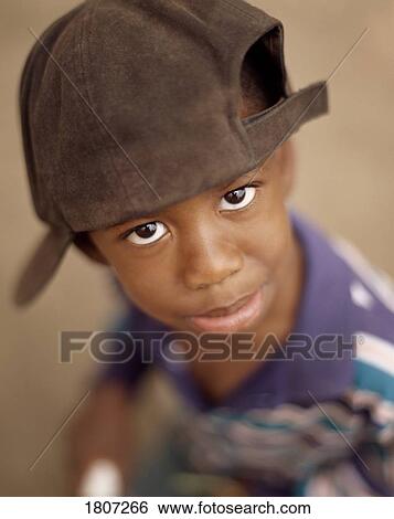 Boy wearing baseball cap and pouting View Large Photo Image Stock Photograph - Boy wearing baseball cap and pouting. Fotosearch