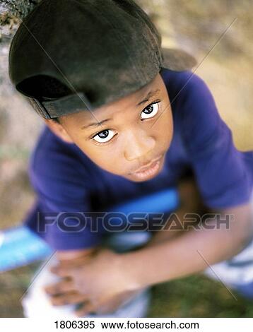 Boy with baseball cap looking up View Large Photo Image Stock Photography - Boy with baseball cap looking up. Fotosearch