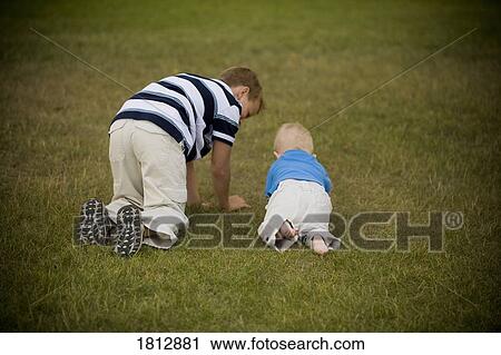 Stock Image - Boys crawling together. Fotosearch