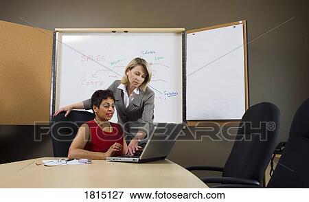 Stock Photo - Business women working together. Fotosearch
