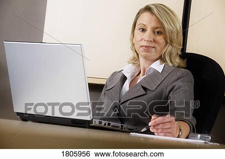 Stock Photograph - Businesswoman working on laptop. Fotosearch