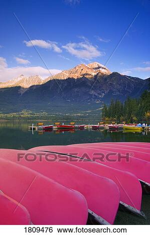 Stock Photograph - Canoes docked at Pyramid Lake, Jasper, Alberta, Canada. Fotosearch
