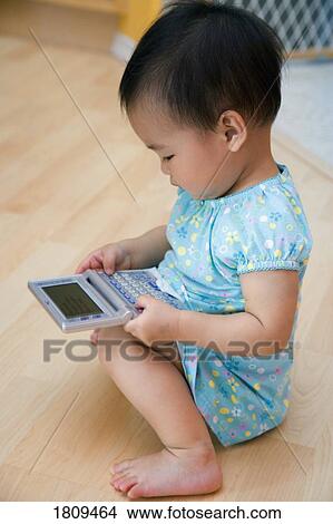 Child playing with mini computer View Large Photo Image Picture - Child playing with mini computer. Fotosearch