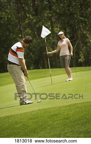 Stock Photo - Couple golfing together. Fotosearch