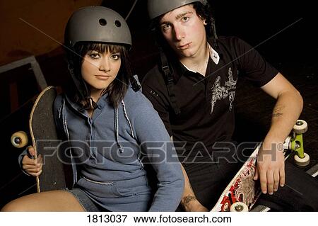 Couple holding skateboard View Large Photo Image Stock Photo - Couple holding skateboard. Fotosearch