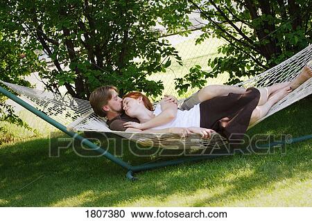 Stock Image - Couple in hammock. Fotosearch