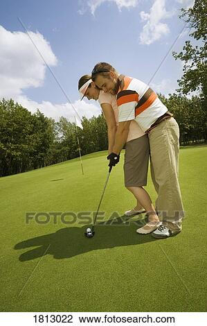 Couple playing golf View Large Photo Image Stock Image - Couple playing golf. Fotosearch