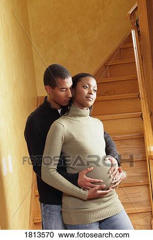 Couple standing together by the staircase View Large Photo Image Stock Image - Couple standing together by the staircase. Fotosearch