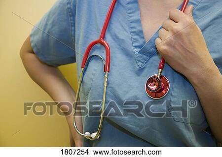Doctor standing with stethoscope View Large Photo Image Picture - Doctor standing with stethoscope. Fotosearch
