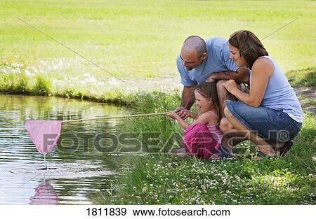 Family down by a pond View Large Photo Image Stock Photo - Family down by a pond. Fotosearch