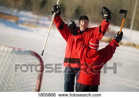 Father and child playing hockey together View Large Photo Image Stock Photograph - Father and child playing hockey together. Fotosearch
