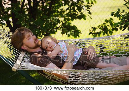 Father and daughter relaxing on a hammock View Large Photo Image Stock Image - Father and daughter relaxing on a hammock. Fotosearch