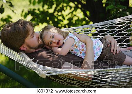Father and daughter relaxing on hammock View Large Photo Image Stock Image - Father and daughter relaxing on hammock. Fotosearch