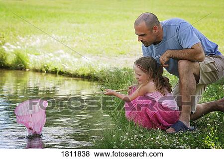 Father and daughter with fishing net View Large Photo Image Stock Photo - Father and daughter with fishing net. Fotosearch