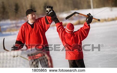 Father playing hockey with son View Large Photo Image Stock Photography - Father playing hockey with son. Fotosearch