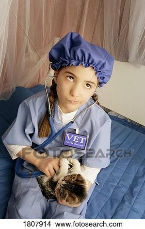 Front view of girl examining cat View Large Photo Image Picture - Front view of girl examining cat. Fotosearch