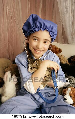 Stock Image - Front view of girl holding cat. Fotosearch