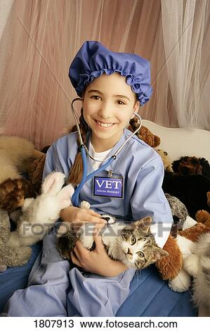 Stock Image - Front view of girl holding cat. Fotosearch