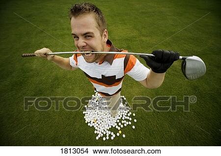 Picture - Frustrated golfer standing with balls. Fotosearch