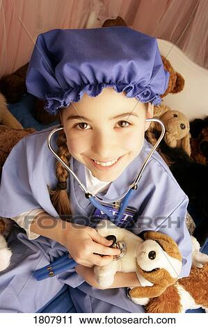 Girl examining teddy bear's prognosis View Large Photo Image Stock Image - Girl examining teddy bear's prognosis. Fotosearch