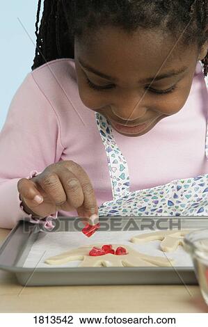 Girl garnishing food View Large Photo Image Stock Image - Girl garnishing food. Fotosearch