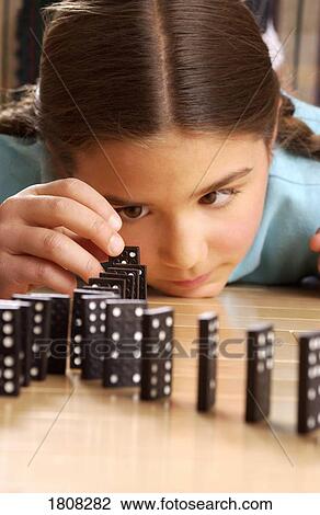 Girl playing dominoes View Large Photo Image Stock Image - Girl playing dominoes. Fotosearch