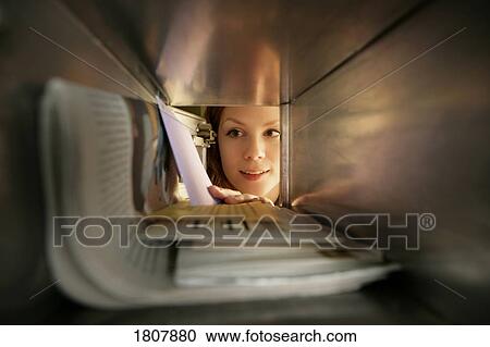 Girl taking mail out of post office box View Large Photo Image Stock Image - Girl taking mail out of post office box. Fotosearch