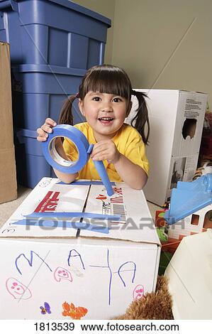 Stock Photo - Girl wrapping a box. Fotosearch