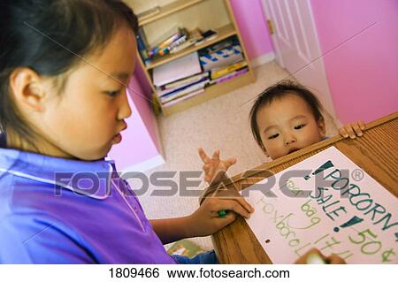 Girl writing with sister watching View Large Photo Image Stock Photograph - Girl writing with sister watching. Fotosearch