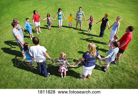 Group holding hands in a circle View Large Photo Image Stock Photo - Group holding hands in a circle. Fotosearch