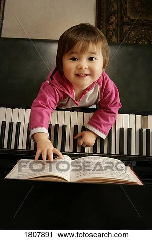 Stock Image - Japanese girl at the piano. Fotosearch